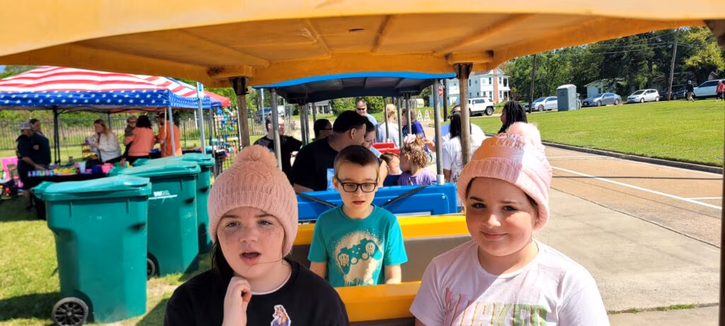 Children enjoying a trackless train ride at an outdoor family event