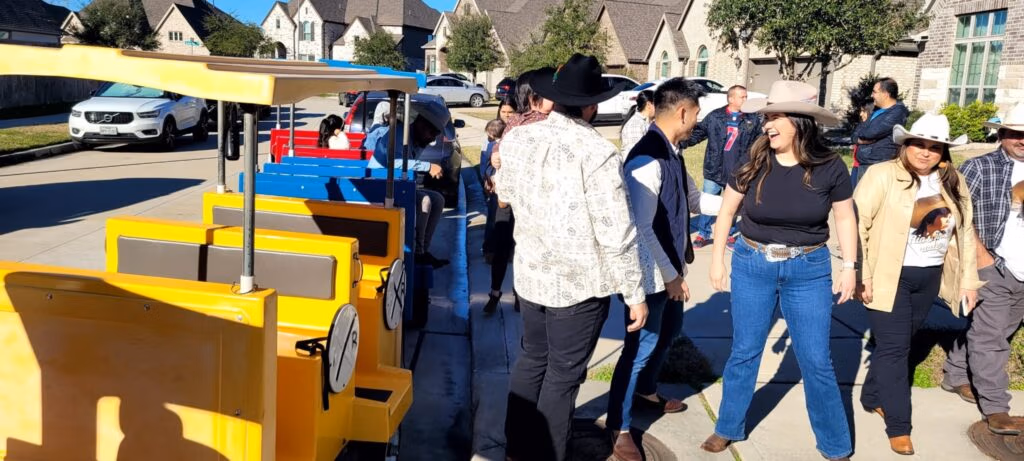 Guests boarding a colorful trackless train for a community event