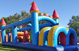 Kids enjoying an inflatable obstacle course challenge