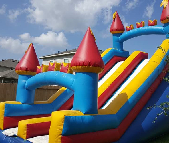 Colorful inflatable slide rental with castle design for kids' parties and outdoor events