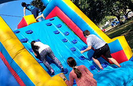 Kids enjoying an inflatable slide at a family event