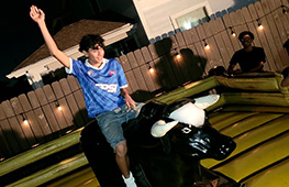 Guests enjoying a mechanical bull ride at a western themed event