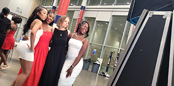 Friends posing together at a photo booth during a celebration